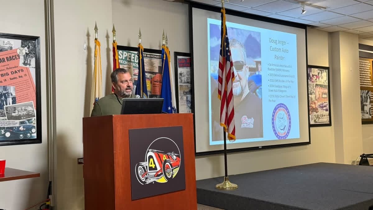 Doug Jerger at the podium at the Museum of American Speed, with his Hall of Fame induction slide on the screen