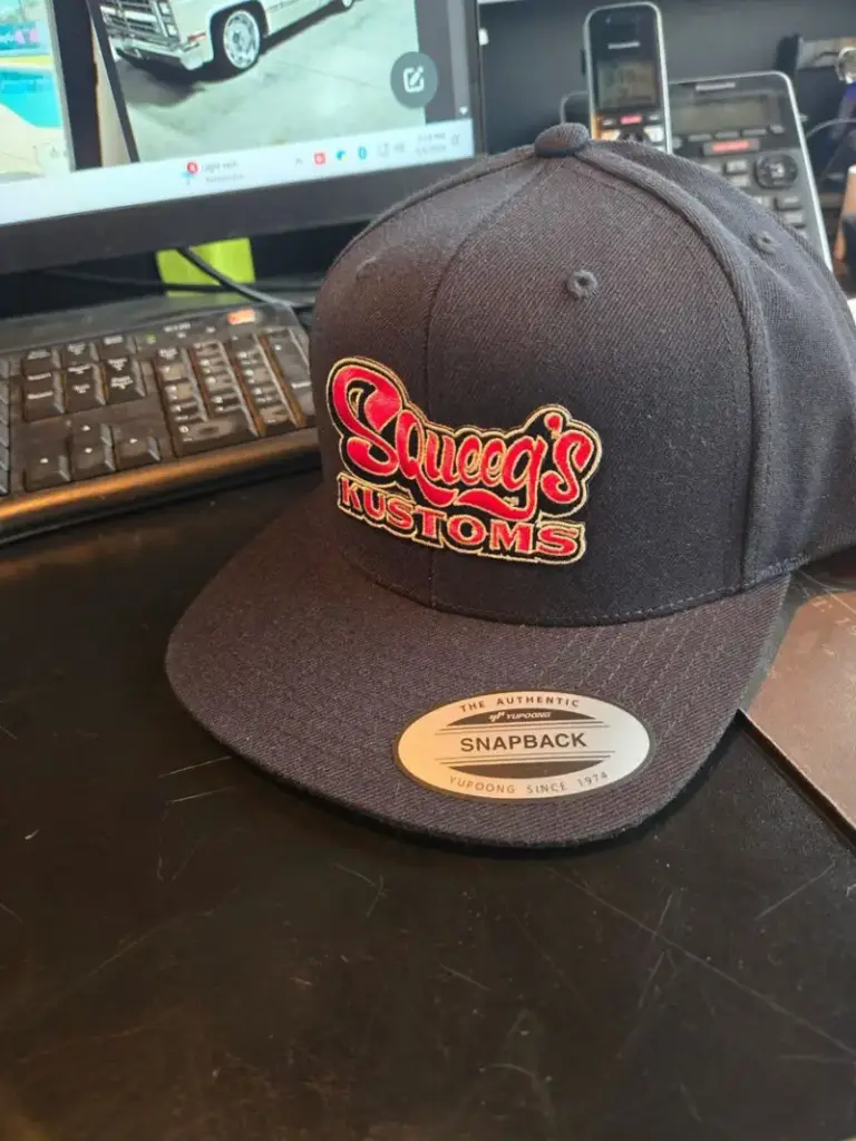 Squeeg’s Kustoms snapback cap with the embroidered script logo